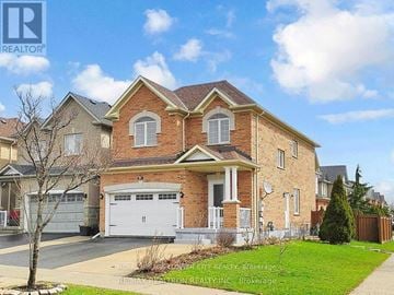 Vaughan (Maple) apartment for rent - A large brick house with a white garage door is for sale.
