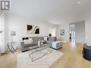 Vaughan (Maple) apartment for rent - A modern living room with a grey sofa and a glass coffee table.