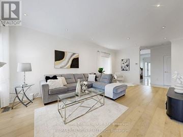 Vaughan (Maple) apartment for rent - A modern living room with a grey sofa and a glass coffee table.