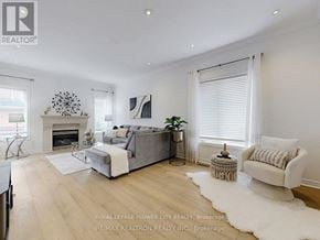 Vaughan (Maple) apartment for rent - A well-lit, spacious living room with a grey sofa and a white rug.