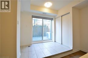 Kitchener townhouse for rent - A room with a sliding glass door leading to a balcony.