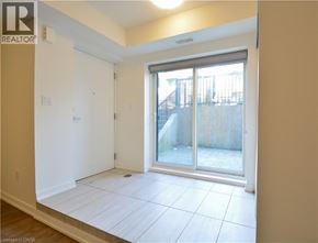 Kitchener townhouse for rent - A room with a sliding glass door leading to a balcony.