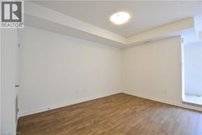 Kitchener townhouse for rent - A room with wooden flooring and white walls.