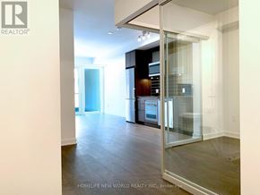 Toronto (Waterfront Communities) condo for rent - A modern kitchen with a glass door.