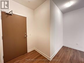 Pickering (Bay Ridges) condo for rent - A room with a brown door and wood flooring.