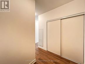 Pickering (Bay Ridges) condo for rent - A room with a sliding door and a wooden floor.