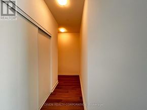 Pickering (Bay Ridges) condo for rent - A hallway with a wooden floor and white walls.