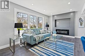Niagara Falls (Ascot) apartment for rent - A living room with a grey couch and a glass coffee table.