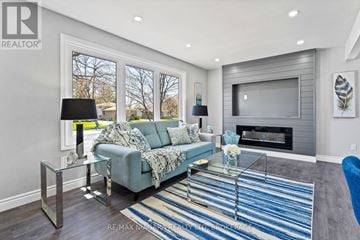 Niagara Falls (Ascot) apartment for rent - A living room with a grey couch and a glass coffee table.