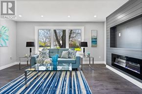 Niagara Falls (Ascot) apartment for rent - A living room with a blue sofa and a fireplace.