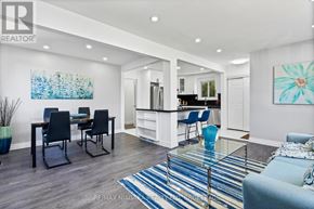 Niagara Falls (Ascot) apartment for rent - A modern living room with a dining area and kitchen in the background.
