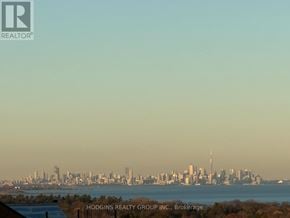 Mississauga (Clarkson) condo for rent - A city skyline is seen in the distance behind a body of water.