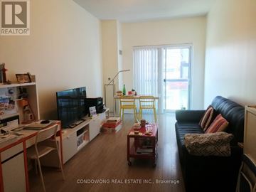 Toronto (Waterfront Communities) condo for rent - A living room with a black couch and a television.