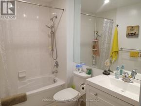 Toronto (Waterfront Communities) condo for rent - A white bathroom with a tub, toilet, and sink.
