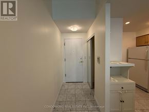Toronto (Waterfront Communities) condo for rent - A white door is in a hallway with a tiled floor.