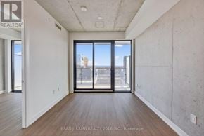 Toronto (Moss Park) condo for rent - A room with a view of the city through large windows.
