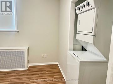 Ottawa apartment for rent - A small kitchen with a white oven and a radiator.