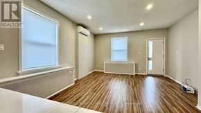 Ottawa apartment for rent - A room with wooden flooring and white walls.