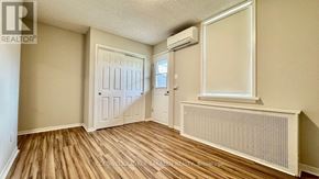 Ottawa apartment for rent - A room with wood flooring and a window with a white frame.