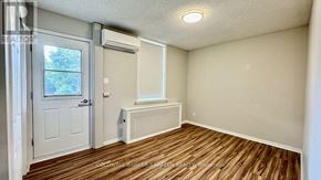 Ottawa apartment for rent - A room with a window, door, and radiator.