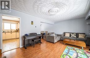 Kitchener apartment for rent - A living room with a grey couch and a wooden coffee table.
