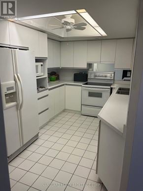 Vaughan (Brownridge) condo for rent - A white kitchen with a refrigerator, oven, and microwave.