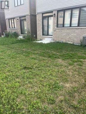 Thorold (Rolling Meadows) apartment for rent - A grassy area in front of a brick building with a sign that says REALTOR.