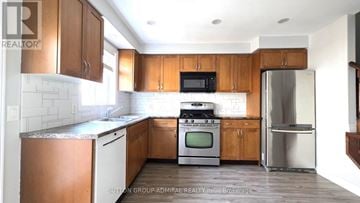 Hamilton (Binbrook) townhouse for rent - A kitchen with wooden cabinets and a stainless steel refrigerator.
