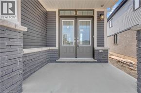 Brantford apartment for rent - A grey door with a glass window is the main focus of the image.
