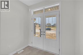 Brantford apartment for rent - A white door with a glass window is in a room with white walls.