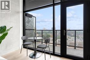 Hamilton apartment for rent - A table with two chairs is in front of a large window.