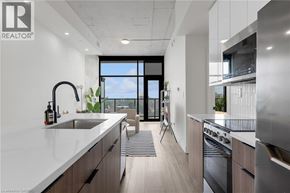 Hamilton apartment for rent - A modern kitchen with a large window overlooking the city.
