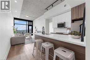 Hamilton apartment for rent - A modern kitchen with white cabinets and a wooden countertop.
