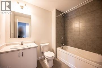Kitchener apartment for rent - A kitchen with a sink, a dishwasher and a counter.