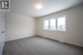 Kitchener apartment for rent - A room with a window and a carpeted floor.