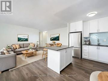 Mississauga (Applewood) condo for rent - A modern kitchen with white cabinets and a wooden island.
