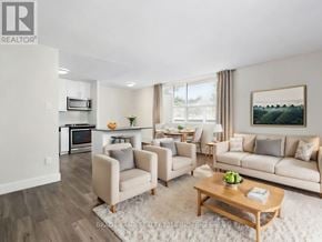 Mississauga (Applewood) condo for rent - A living room with a couch, chairs, and a coffee table.
