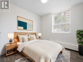 Mississauga (Applewood) condo for rent - A bedroom with a bed, nightstand, and a painting on the wall.