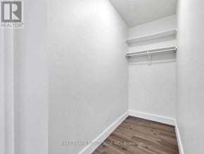 Mississauga (Applewood) condo for rent - A white room with a wooden floor and a closet with a shelf.