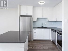 Mississauga (Applewood) condo for rent - A kitchen with white cabinets and a black countertop.