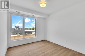 Kitchener condo for rent - A room with a large window showing a view of a residential area.