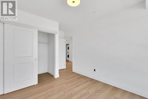 Kitchener condo for rent - A room with a white door and a white wall with a light on.
