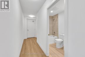 Kitchener condo for rent - A white bathroom with a toilet and sink.