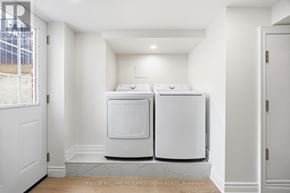 Toronto (South Parkdale) apartment for rent - A white kitchen with two ovens and a marble floor.