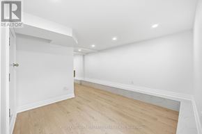 Toronto (South Parkdale) apartment for rent - A room with a white wall and wooden floor.