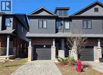 Hamilton townhouse for rent - A house with a grey siding and a red fire hydrant in front.