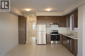 Hamilton townhouse for rent - A modern kitchen with a refrigerator, stove, and oven.