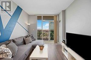 Mississauga (Rathwood) condo for rent - A living room with a grey couch and a coffee table.