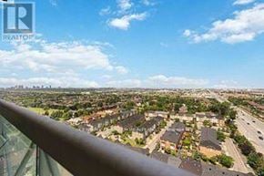 Mississauga (Rathwood) condo for rent - A real estate company logo is visible on a balcony railing overlooking a residential neighborhood.