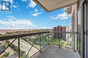 Mississauga (Rathwood) condo for rent - A balcony with a glass railing overlooks a cityscape.